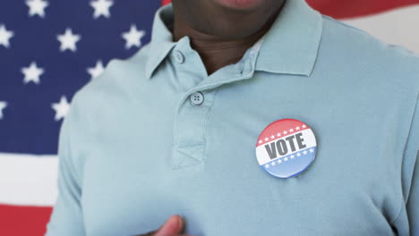 wearing vote button, person standing in front of american flag animation