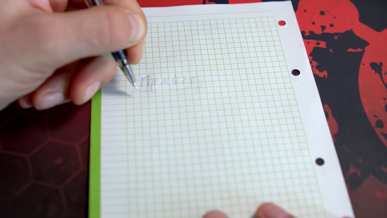 Creative hands sketch and write on lined paper, showcasing artistic process. A notebook sits on a textured surface with a vibrant design
