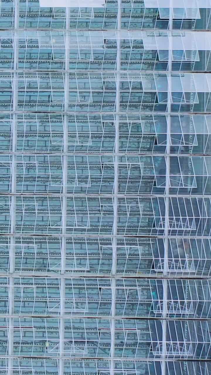 Large glass greenhouse. Aerial view farming vegetable cultivation agriculture industry. Transparent glass roof for vegetables. Vertical video