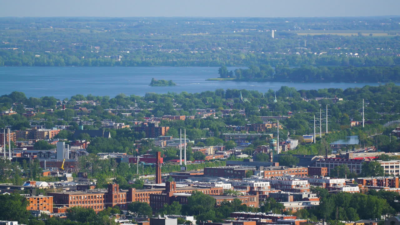 Montreal Horizon. A pull into focus shot of the landscape of Montreal neighborhoods. The St. Lawrence River is pictured and the horizon line is so very far int he distance. Beautiful Montreal.