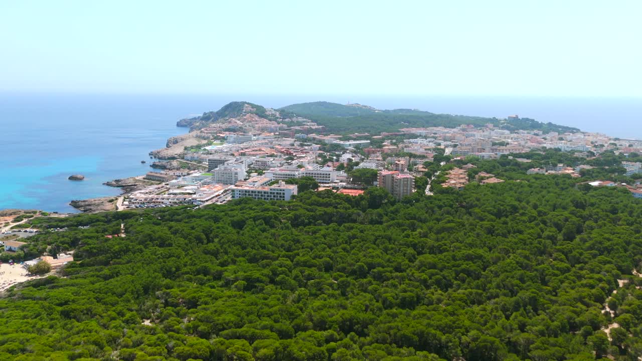 Cala Ratjada town on peninsula with forest and beach in Mallorca, aerial view