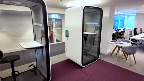 modern office featuring innovative soundproof pods, providing employees with private and quiet workspaces for focused productivity