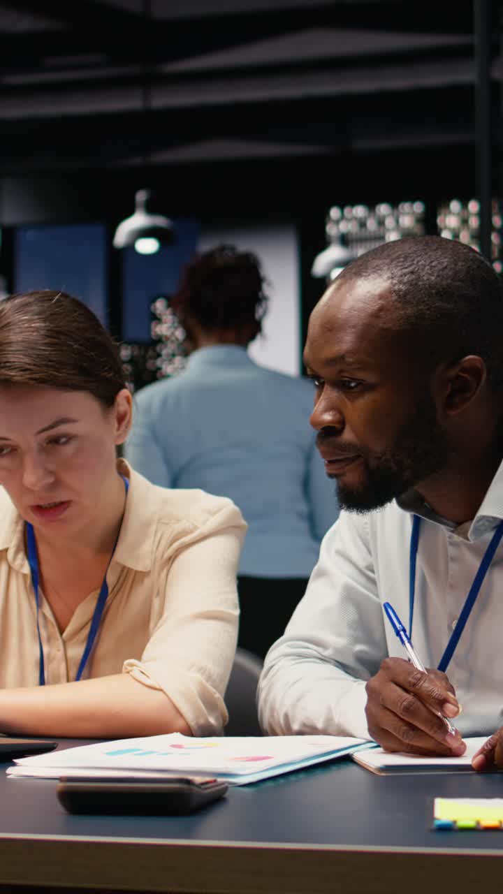 Vertical Video Diverse business team working together in office late at night