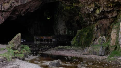 establishing shot of the famous smoo cave on the nc500 route in scotland