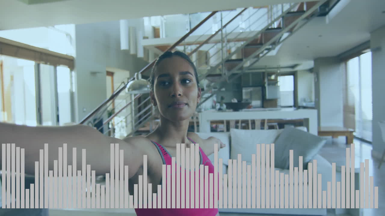 Female athlete performing balance exercise in living room, animated fitness chart floating