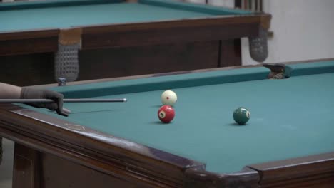 a player shoots during a pool game.