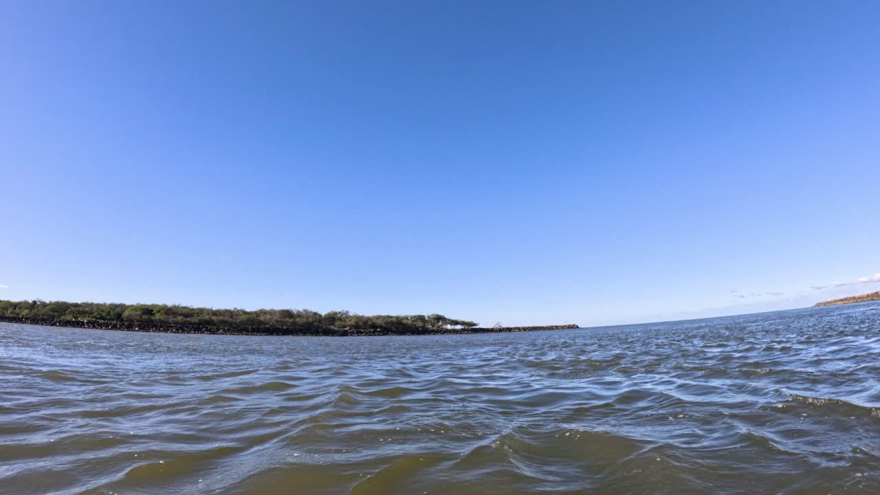 olas y horizonte bajo un cielo azul claro