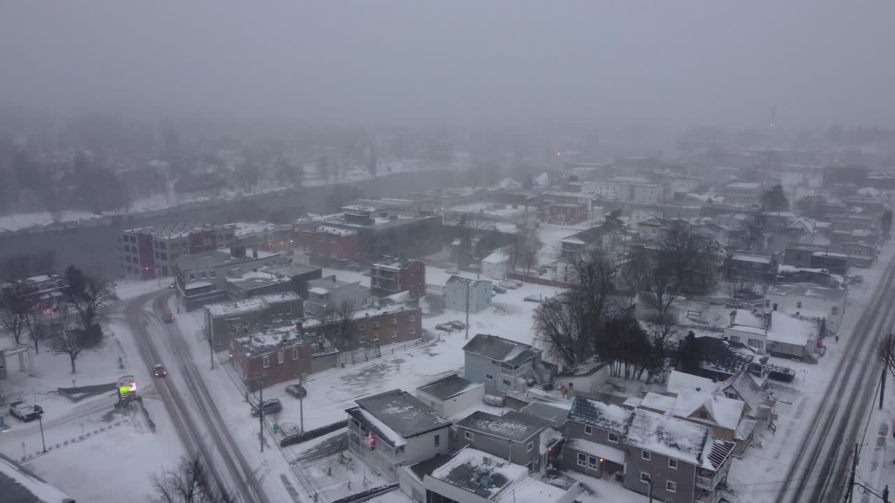 Snow-covered town in Orford, Québec, captured from an aerial view on a foggy winter day