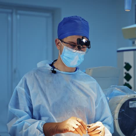 neurosurgeon talking on camera in clinic. medical specialist in mask showing medical appliance in the operating room. portrait of a doctor.