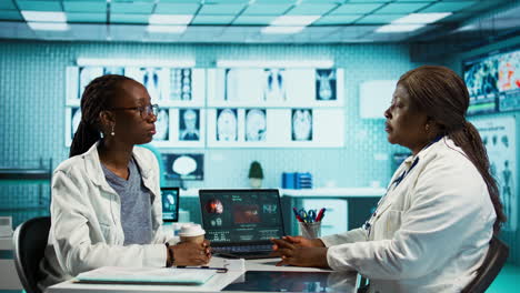 black female specialist discussing health care concerns with a young patient