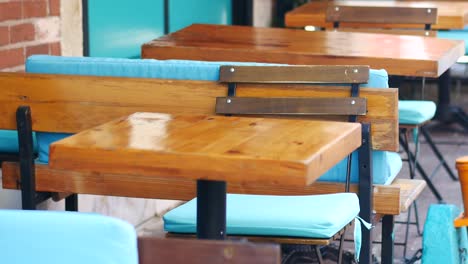 empty tables and chairs at an outdoor cafe