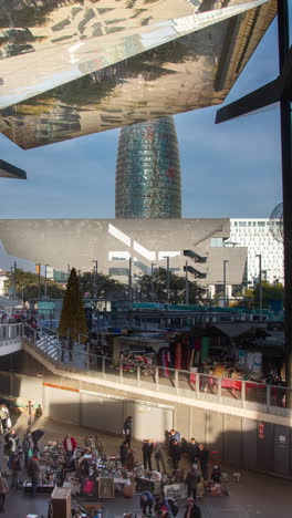 timelapse of the encants second hand market in barcelona and skyline behind in vertical