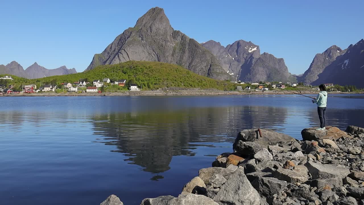 Woman fishing on Fishing rod spinning in Norway.