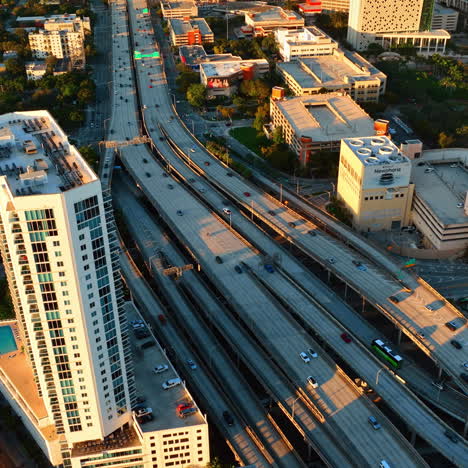 lively multi-lane speedway with cars running by. highway in downtown of miami, florida, usa at sunset. top view.