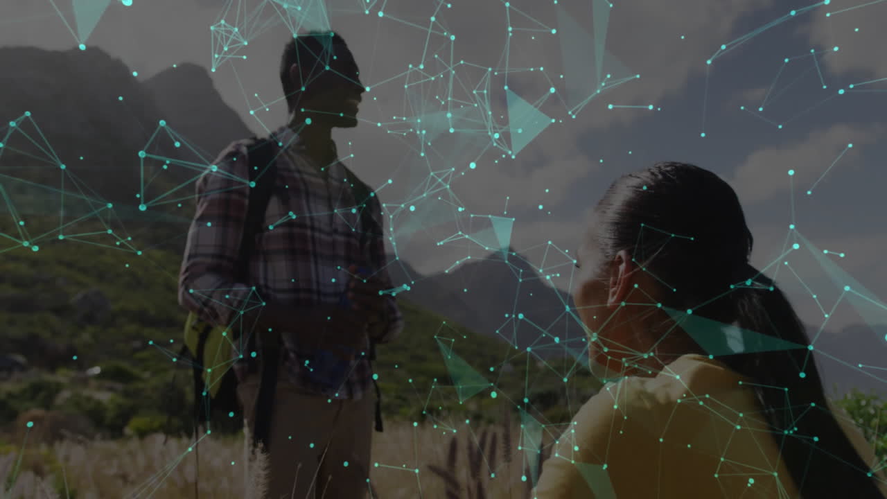 Hiking partners carrying backpack and water bottle in grassland, showing technology network overlay