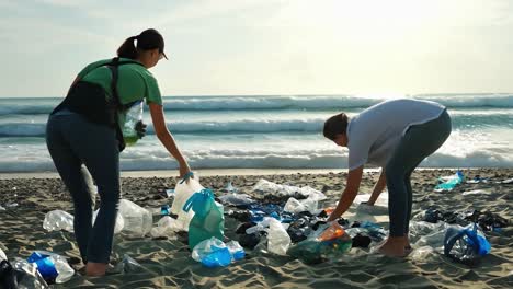 volunteers cleaning up plastic pollution on a beach