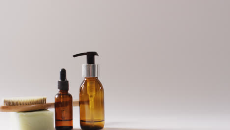 close up of different beauty products on white background with copy space