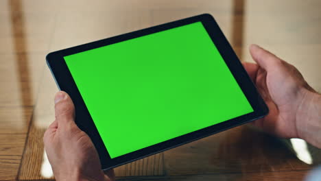 man hand touching green tablet screen indoor closeup. manager using computer