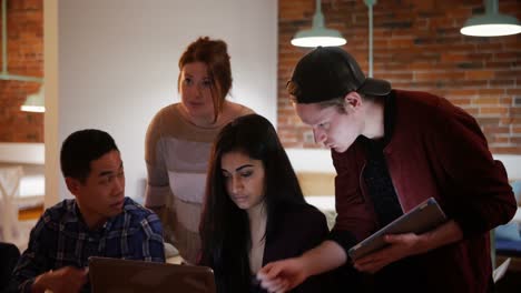 Executives-discussing-over-laptop-in-creative-office-4k