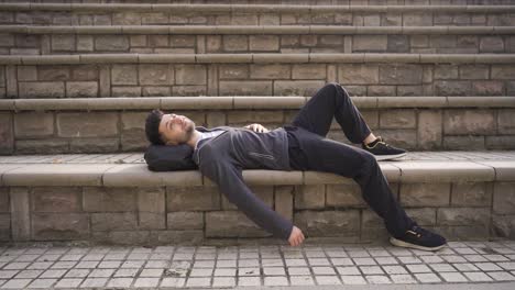 happy young man lying outdoors, resting. lazy teenager.