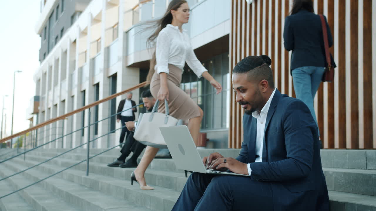 Businessman working on a laptop outside