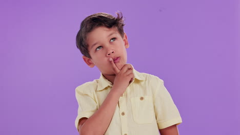 young boy thinking on purple background