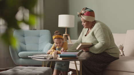 granny helping schoolchild doing homework