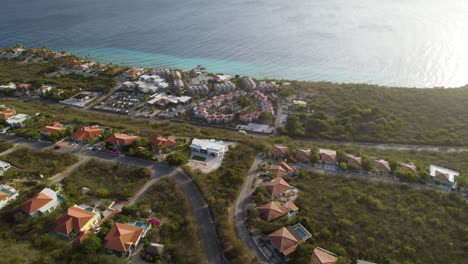 aerial establishing shot of the residential area on the tropical island with emerald sea waters