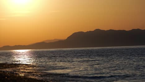 Olas-Del-Océano-Rodando-Hacia-La-Playa-Al-Atardecer-En-La-Isla-De-Rodas-En-Grecia