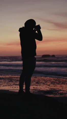 silhouette of photographer at sunset beach