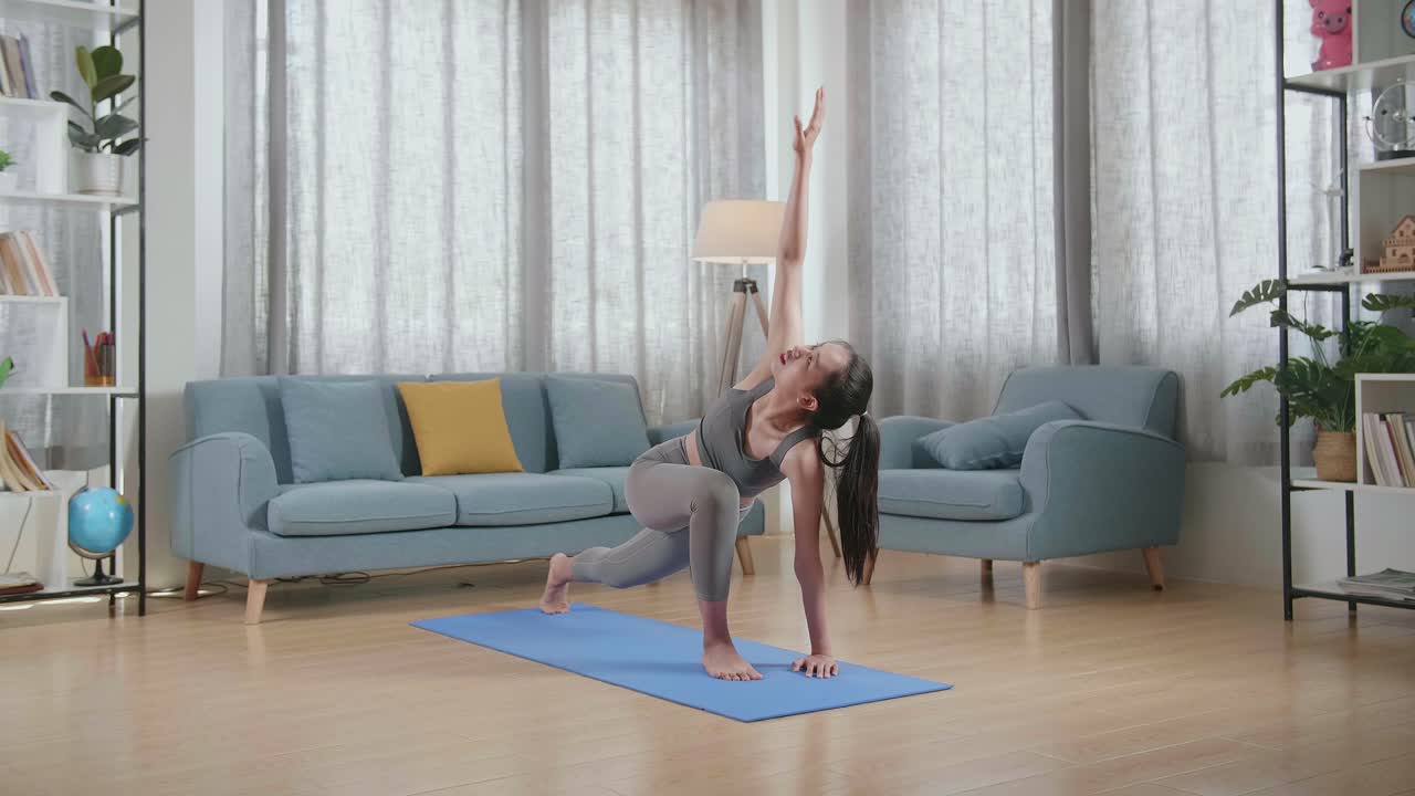 joven atleta asiática haciendo ejercicio, estirándose y practicando yoga en casa. estilo de vida saludable, fitness, bienestar y concepto de atención plena