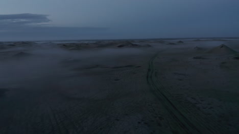 Drone-view-desolate-landscape-of-Iceland-in-a-foggy-misty-day.-Birds-eye-of-empty-icelandic-highlands.-Wilderness-countryside.-Desolation,-loneliness-concept