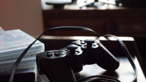 A video game controller and a composite video cable resting on a gaming desk