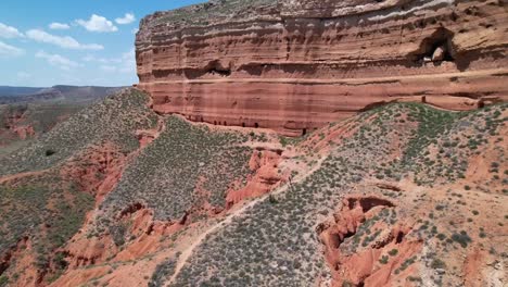 Excursionista-Subiendo-A-Una-Montaña-Roja-Mística-En-Un-Desierto-De-Cañón-Rojo-En-Teruel,-España