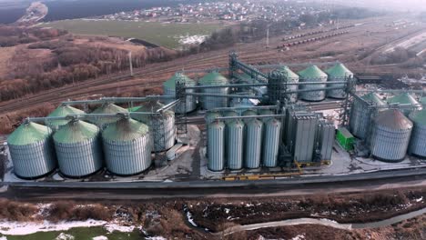 metal silos on field aerial view. large containers for storing and processing grains. silver grain elevators in farmland. storage tank view from above. silo with grain.