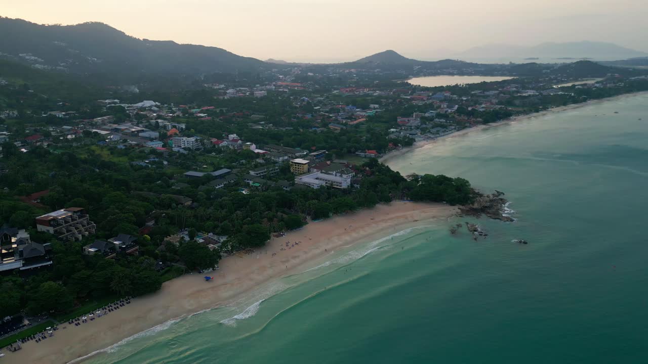 Aerial of Koh Samui Chaweng drone fly above gulf of Thailand famous beach travel holiday destination town at sunset