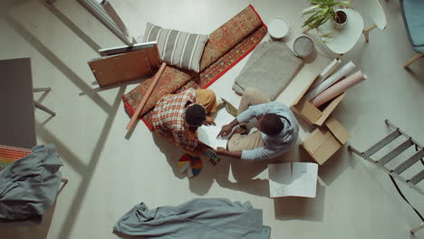 African-American-Couple-Discussing-Paper-Plans-during-Home-Renovation