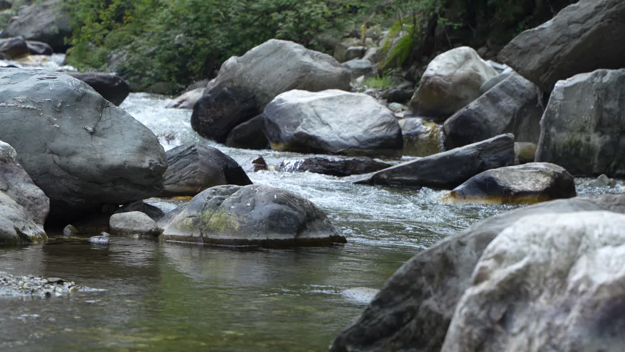 Water is flowing through a mountain torrential river.