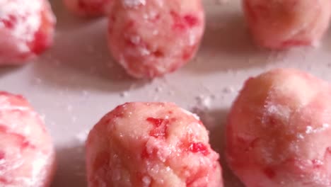 Close-up-of-cherry-cordial-holiday-cookie-dough-rolled-and-prepared-to-bake-in-the-oven