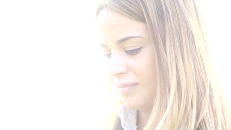 woman outside turns to camera and smiles