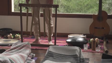 close up shot of person playing tubular bells inside yoga room