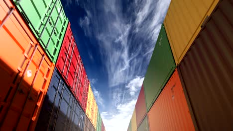 stacks of shipping containers under afternoon cloudscape seamless loop