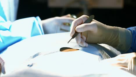 close-up of surgeons performing operation in operation room