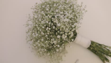 two wedding bride and bridesmaids bouquets of white gypsophila flowers lie down on white background