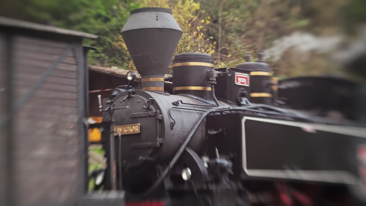 View of the wound-up steam train Mocanita on a railway station, Romania. Lensbaby effect