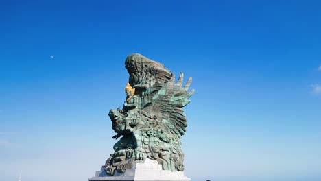 aerial of bali's patung garuda wisnu kencana, awe-inspiring statue that depicts the hindu god vishnu riding atop the mythical bird garuda