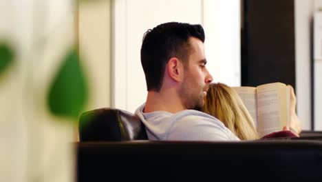 pareja acostada en el sofá y leyendo libros
