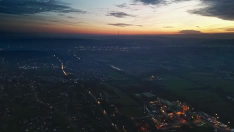 cinematic aerial sunset night vertical view of city street traffic, buildings, england, uk