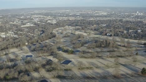 aerial view over golf course during winter off season in city, 4k