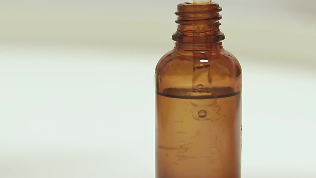 Showcasing an organic skin serum in a glass bottle dropper shot in close up selective focus depicting health, beauty and skincare industry